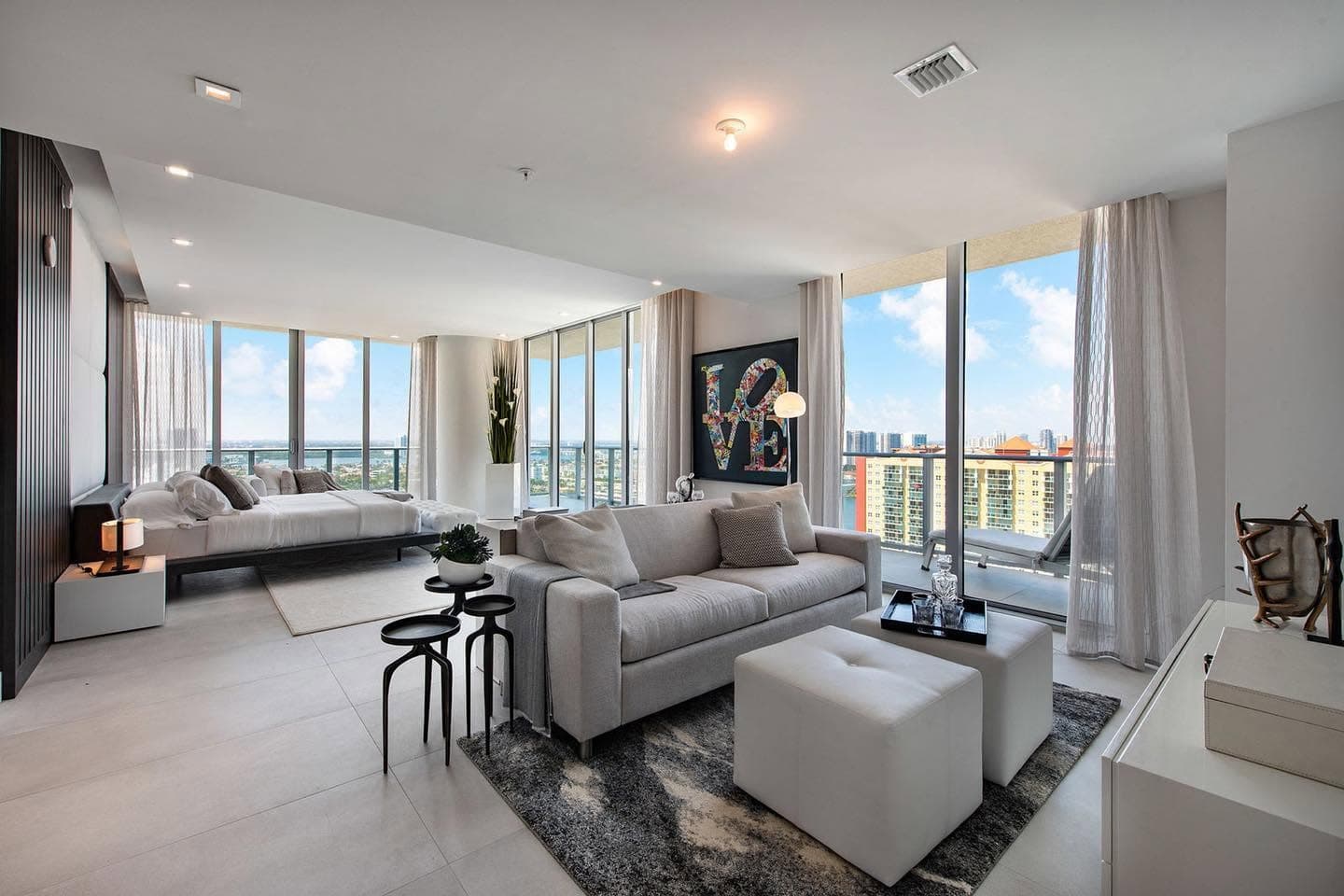 Open-concept living area and bedroom with skyline views